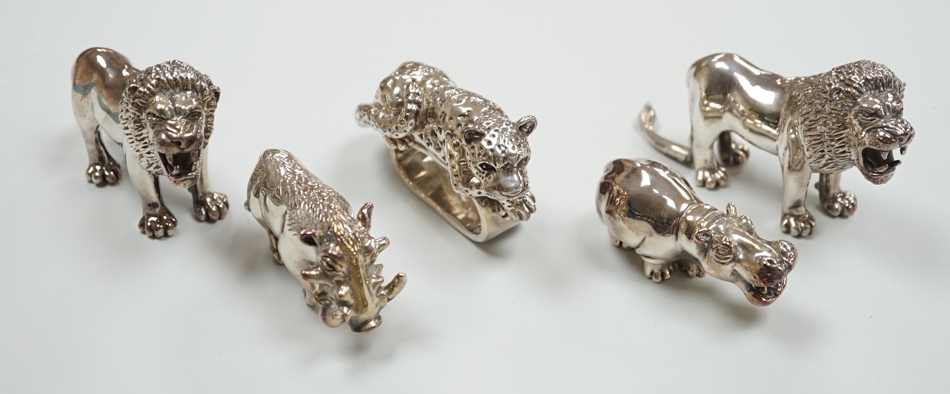 Four modern 925 overlaid miniature models of animals including two lions and a similar leopard napkin ring (one lion a.f.).